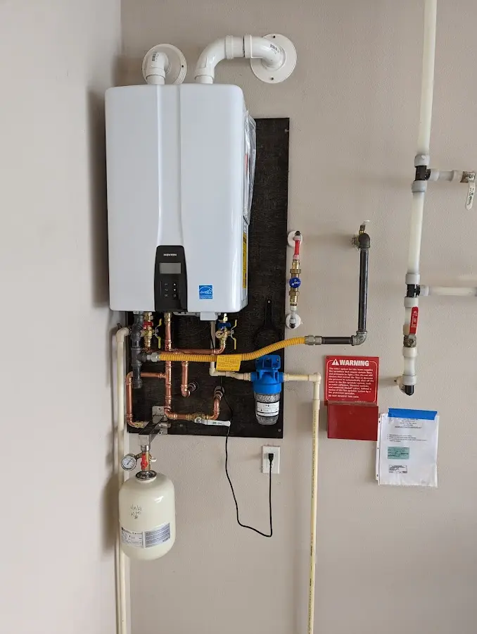 Professional plumber installing copper piping in a River Ridge home